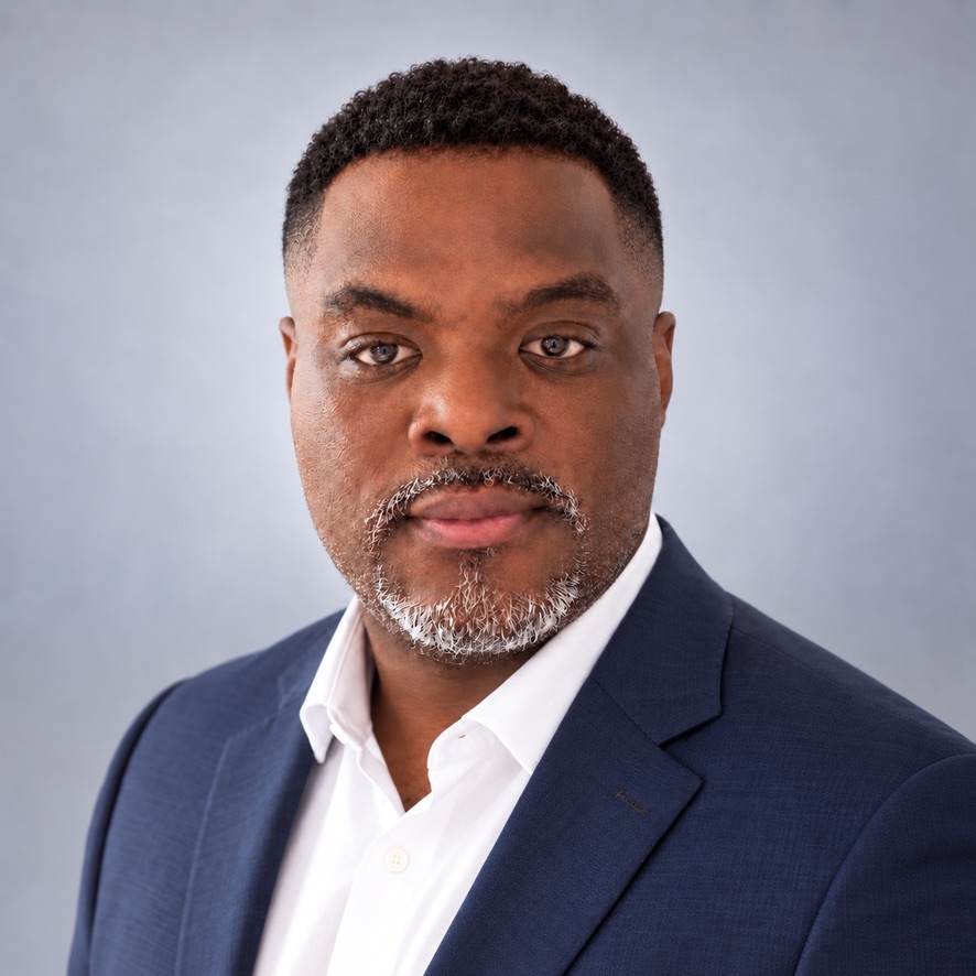 Sebastien Laurore wearing a navy blazer and white shirt